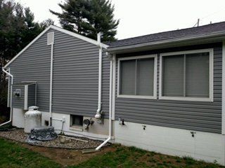 Charcoal vinyl siding with new windows
