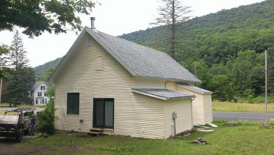 Cream farmhouse with a new roof and mountain views