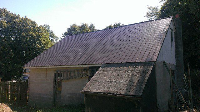 Brown standing-seam metal roof on a detached garage